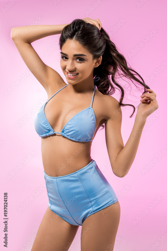 beautiful smiling girl posing in trendy bikini, isolated on pink beautiful smiling girl posing in trendy bikini, isolated on pink