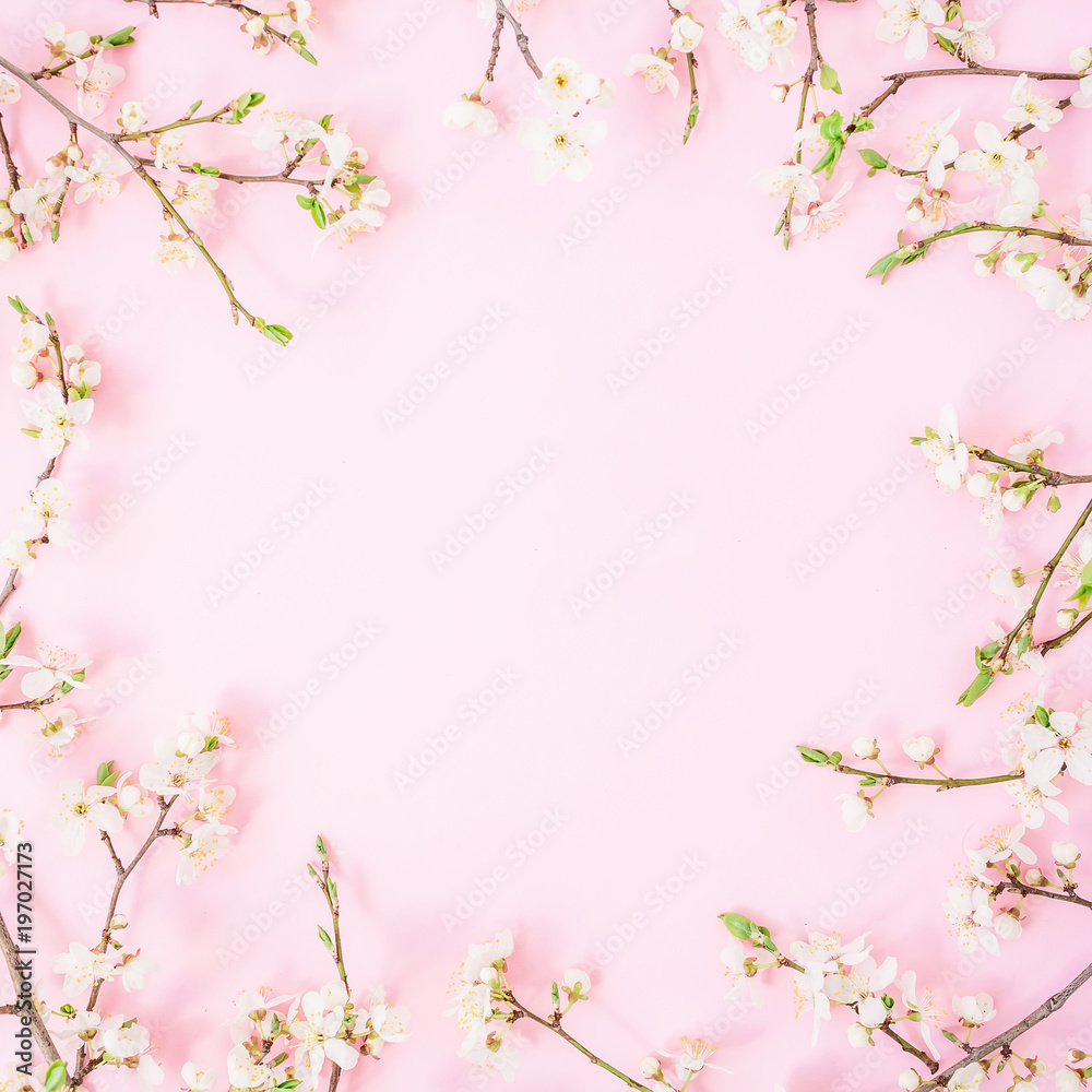 Frame of spring flowers isolated on pastel background. Flat lay, top view. Spring time background.
