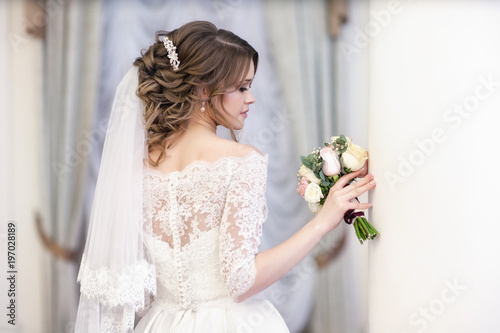portrait of the bride on the window background