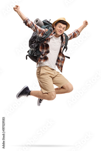 Teenage tourist jumping and gesturing happiness