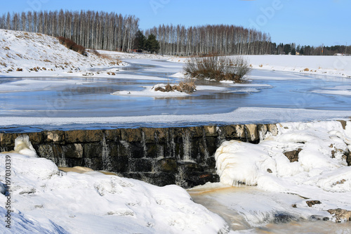 Winter landscape in Finland. Frozen Aura River and rapids Nautelankoski in Lieto, near Turku.  photo