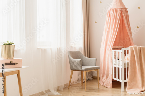 Chair by windows and crib