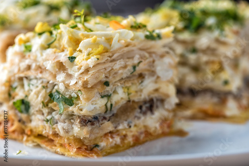Fish pie with a dough, egg and fresh herbs, macro photo