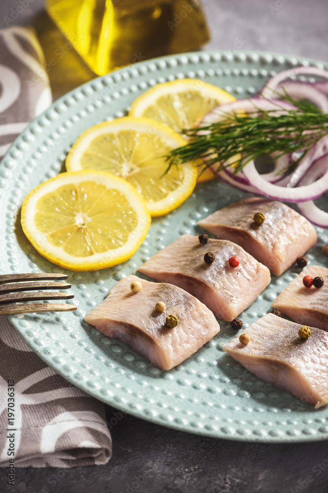 Pickled herring with red onion and lemon slices. Pickled herring with red onion and lemon slices.