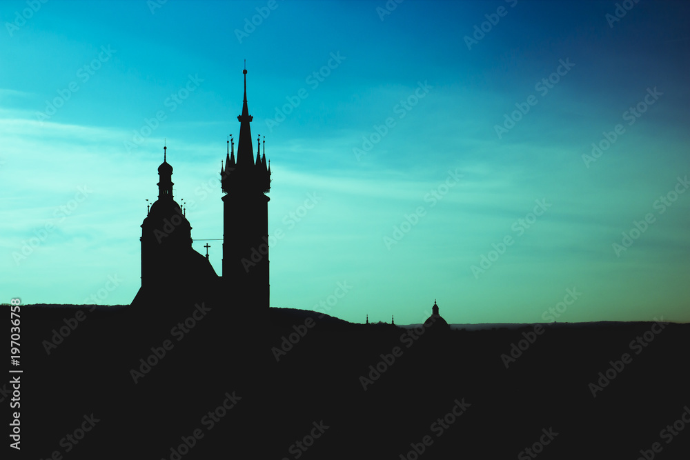Black silhouette St. Mary Basilica in Krakow and panorama of the city center against a background fantastic blue and azure sky