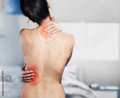 Woman touching her painful back