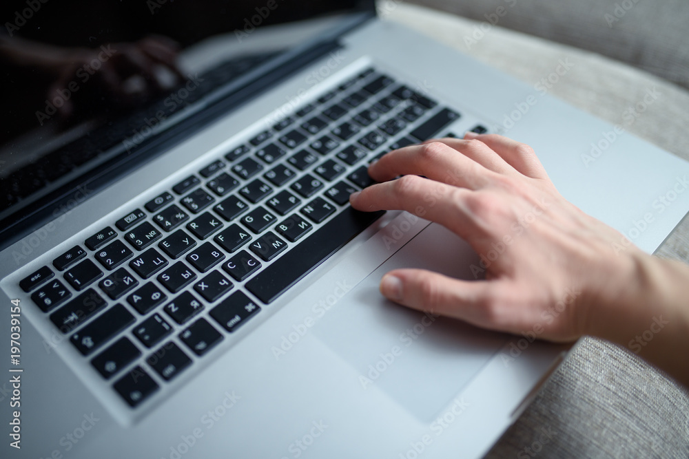 Black laptop keyboard. Close up of hand working on lap top, small depth of field Black laptop keyboard. Close up of hand working on lap top, small depth of field