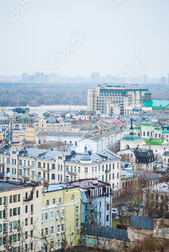 City of Kyiv  Kiev   capital of Ukraine  panorama. Colorful houses and Dnipro river on a background. Cloudy spring afternoon. Filtered.