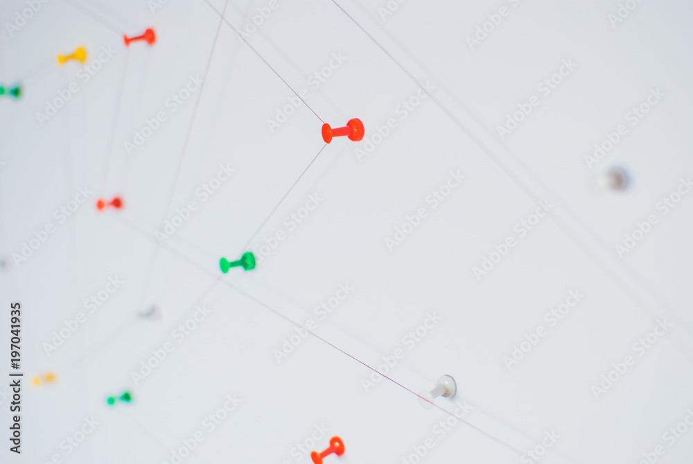 Background. Abstract concept (idea) of network, social media, internet, teamwork, communication abstract. Colorful push pins linked together by red thread. Isolated. Entities connected. Background. Abstract concept (idea) of network, social media, internet, teamwork, communication abstract. Colorful push pins linked together by red thread. Isolated. Entities connected.