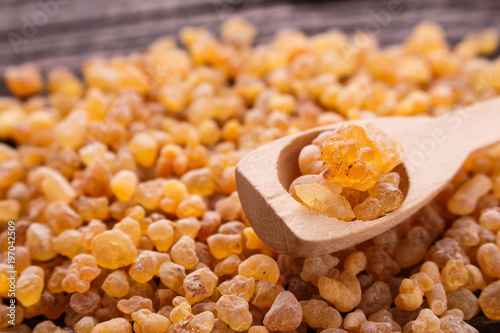 frankincense essential oil on a wooden background