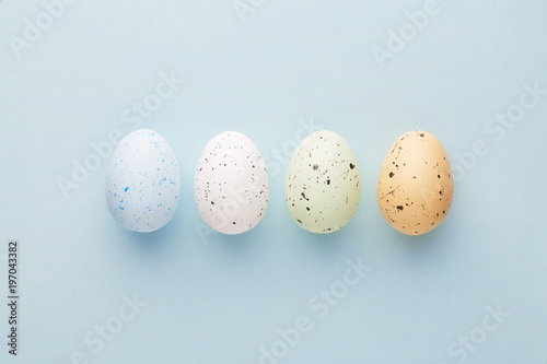 Easter eggs selection on a pastel blue background viewed from above. Top view. Copy space