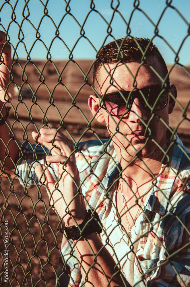 man and fence with shadow on his face (counrtyside vintage concept) man and fence with shadow on his face (counrtyside vintage concept)