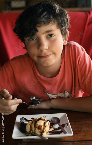 teenager sweet tooth boy eat lava cake in confectionery cofe shop close upphoto photo