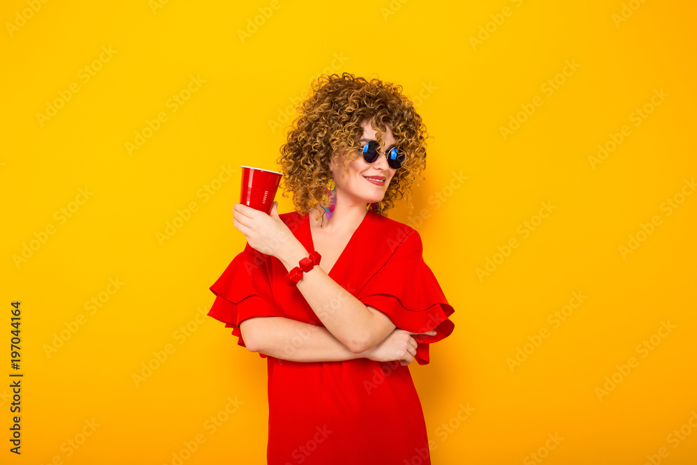 Attractive woman with short curly hair and drink Attractive woman with short curly hair and drink