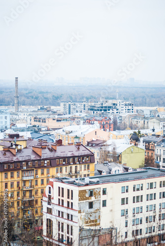 City of Kyiv  Kiev   capital of Ukraine  panorama. Colorful houses and Dnipro river on a background. Cloudy spring afternoon.