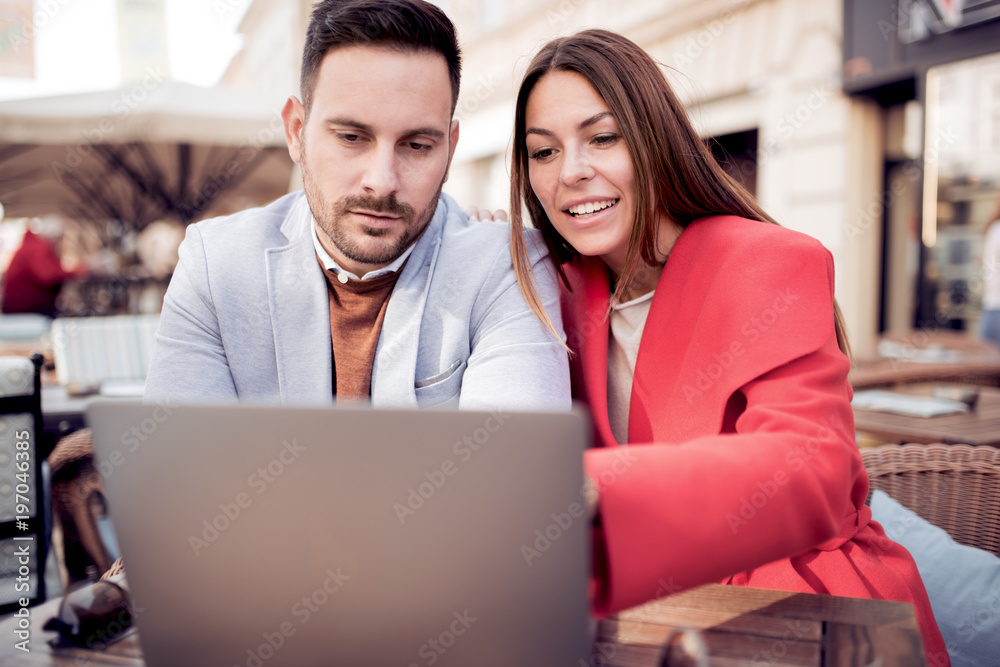 Couple with laptop in cafe Couple with laptop in cafe