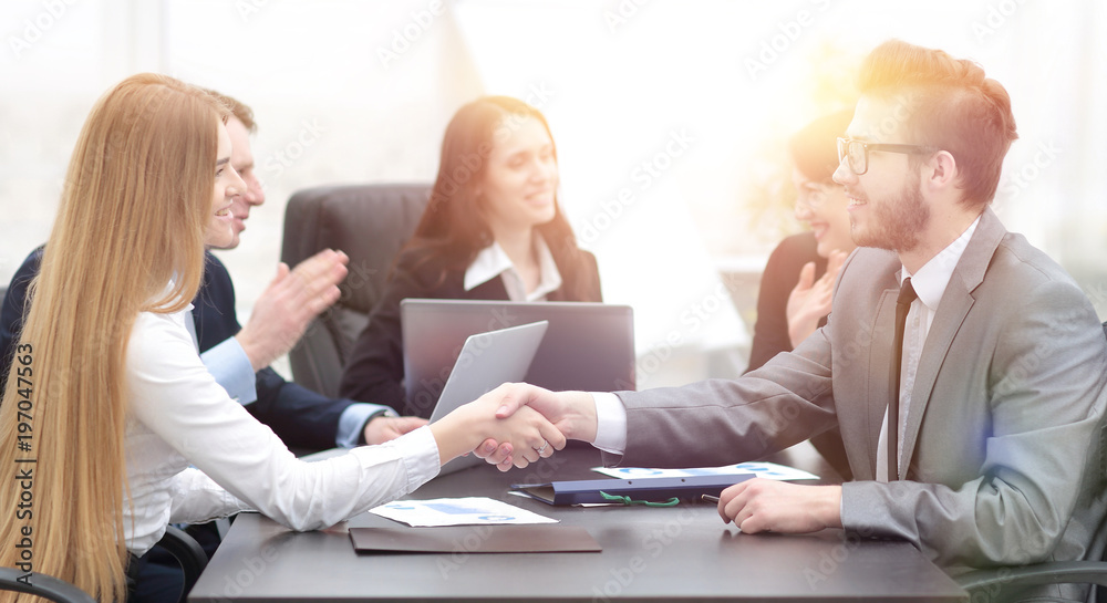 handshake between a businesswoman and a businessman handshake between a businesswoman and a businessman