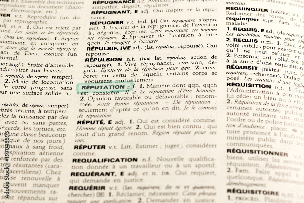 Close up of french dictionary page with word reputation