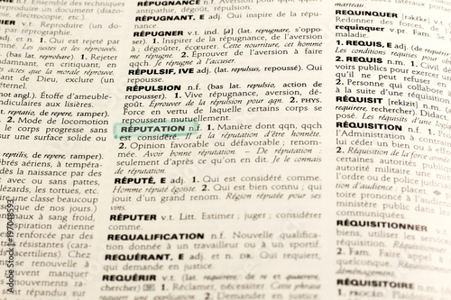 Close up of french dictionary page with word reputation