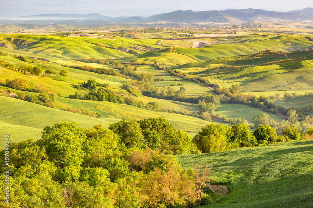 Idyllic landscape view of rolling fields and valleys of Tuscany Idyllic landscape view of rolling fields and valleys of Tuscany