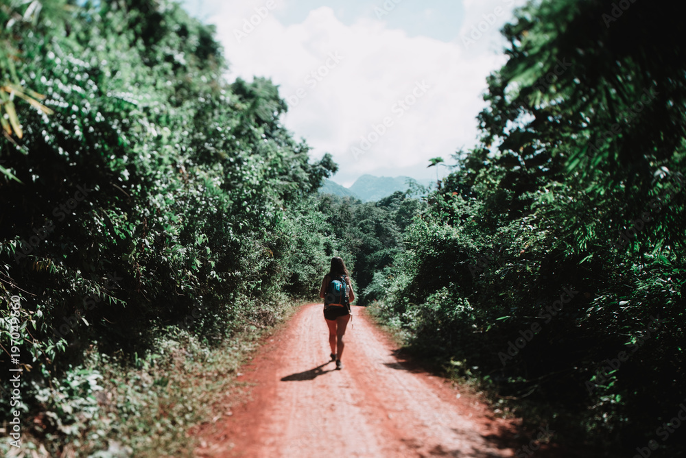 Tourist woman walking on road Tourist woman walking on road