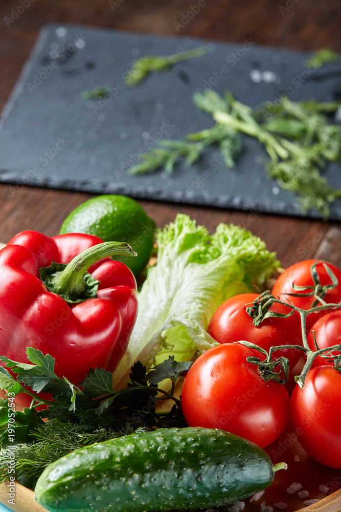 Close-up still life of assorted fresh vegetables and herbs on vintage wooden background, top view, selective focus. Close-up still life of assorted fresh vegetables and herbs on vintage wooden background, top view, selective focus.