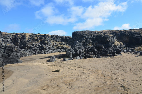 Beautiful blue skies above a large rock formation in Iceland photo