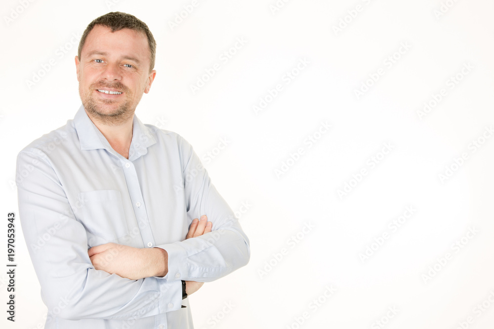 Confident handsome man in shirt arms crossed and smiling while standing against white background Confident handsome man in shirt arms crossed and smiling while standing against white background
