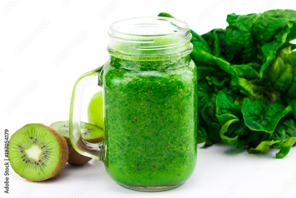 Healthy green smoothie with spinach and kiwi in a jar mug isolated on white Healthy green smoothie with spinach and kiwi in a jar mug isolated on white