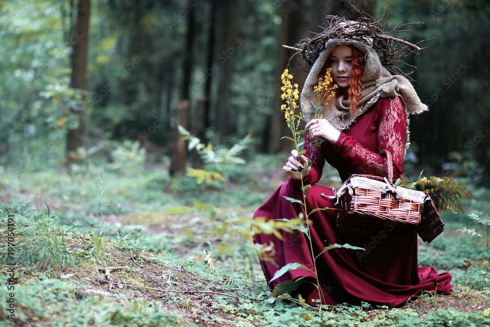 The red-haired witch holds a ritual with a crystal ball The red-haired witch holds a ritual with a crystal ball