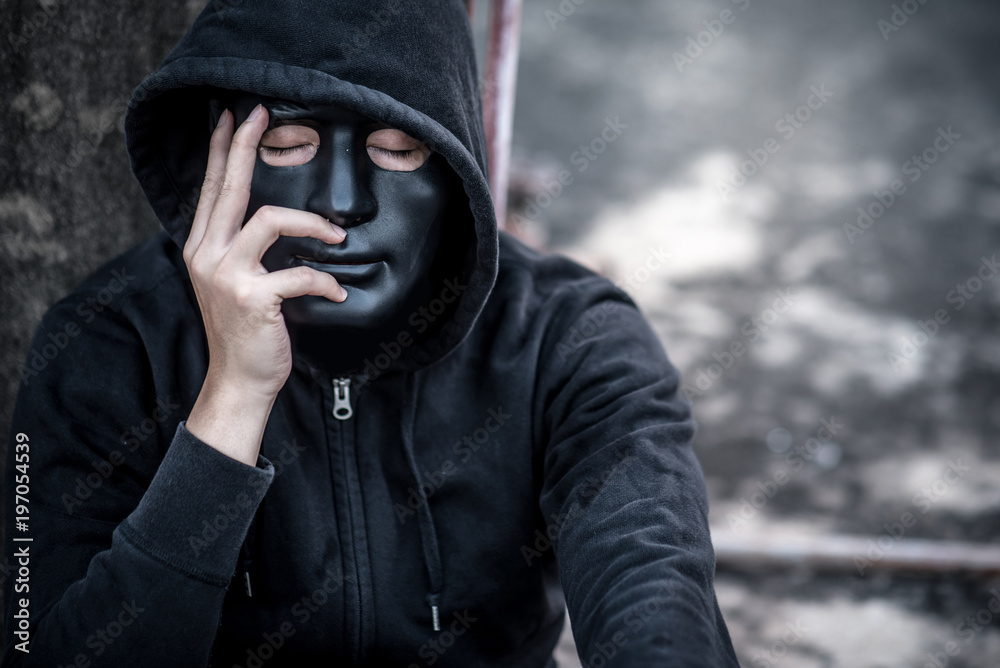 Mystery man in black mask with hoody jacket close his eye thinking of something. feeling stressed or headache gesture Mystery man in black mask with hoody jacket close his eye thinking of something. feeling stressed or headache gesture