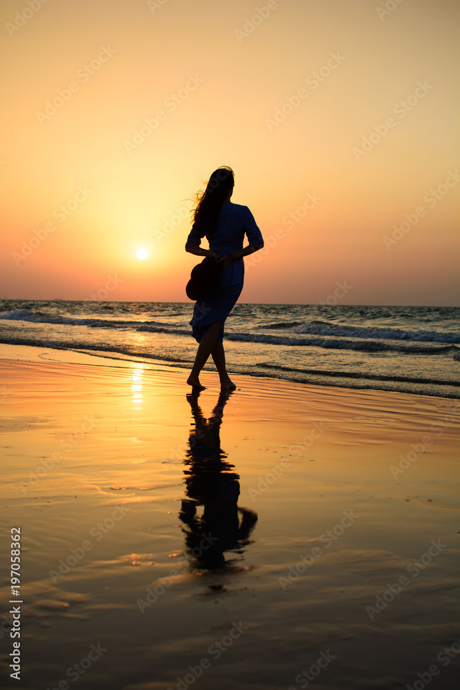 Girl on the beach at sunset