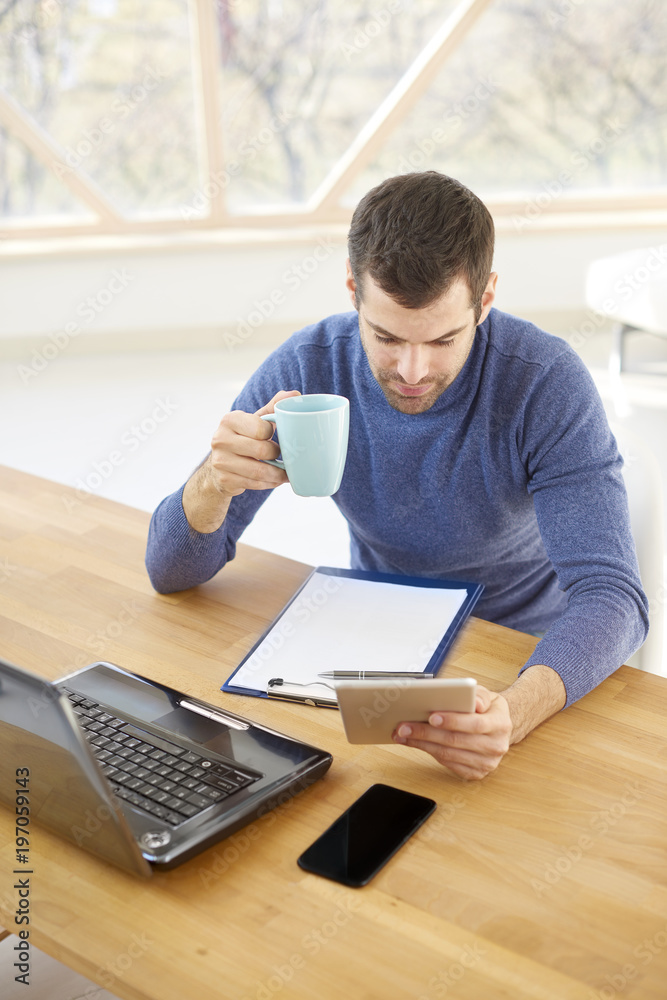 Businessman checking e-mails on digital tablet Businessman checking e-mails on digital tablet