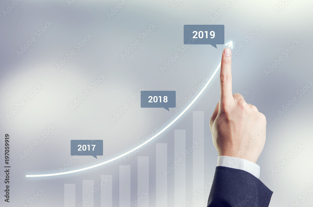 Growth in 2019 year concept. Hand of businessman plan growth and increase of positive indicators in his business. Growth in 2019 year concept. Hand of businessman plan growth and increase of positive indicators in his business.
