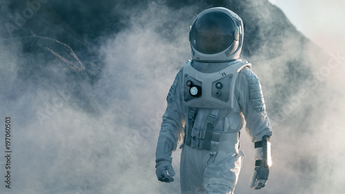 Fototapeta Naklejka Na Ścianę i Meble -  Shot of Astronaut Walking on Alien Rocky Planet that is Covered with Gas and Smoke. Humans Overcoming Difficulties. Scientific Progress.