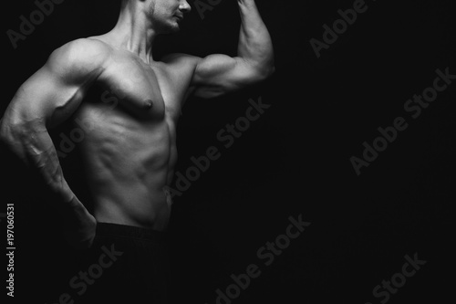 Strong athletic man showes naked muscular body