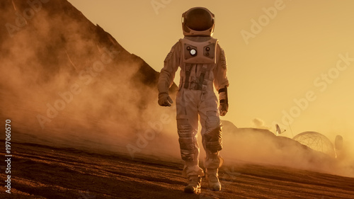 Brave Astronaut Confidently Walks on Mars Surface. Red Planet Covered in Gas and rock,  Overcoming Difficulties, Important Moment for the Human Race.