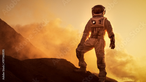 Silhouette of the Astronaut Standing on the Rocky Mountain of the Alien Red Planet/ Mars. First Manned Mission on Mars. Space Exploration, Colonization.