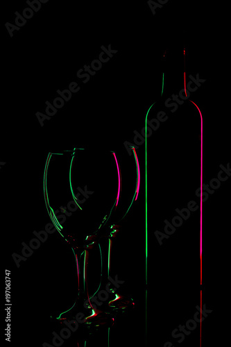 neon silhouettes of wine bottle and two glasses on black background