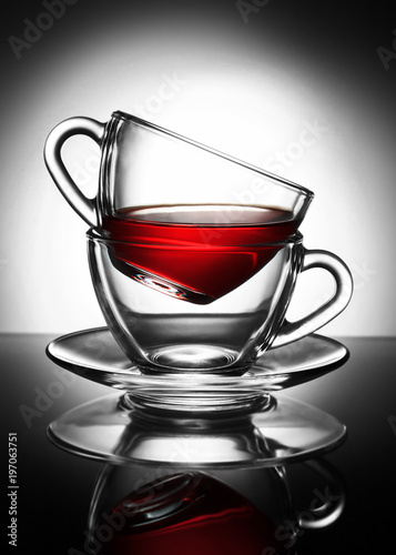 transparent Cup of tea in a Cup on a saucer on the gradient background