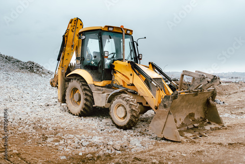 Industrial road construction site, highway building. Heavy duty machinery backhoe excavator on site