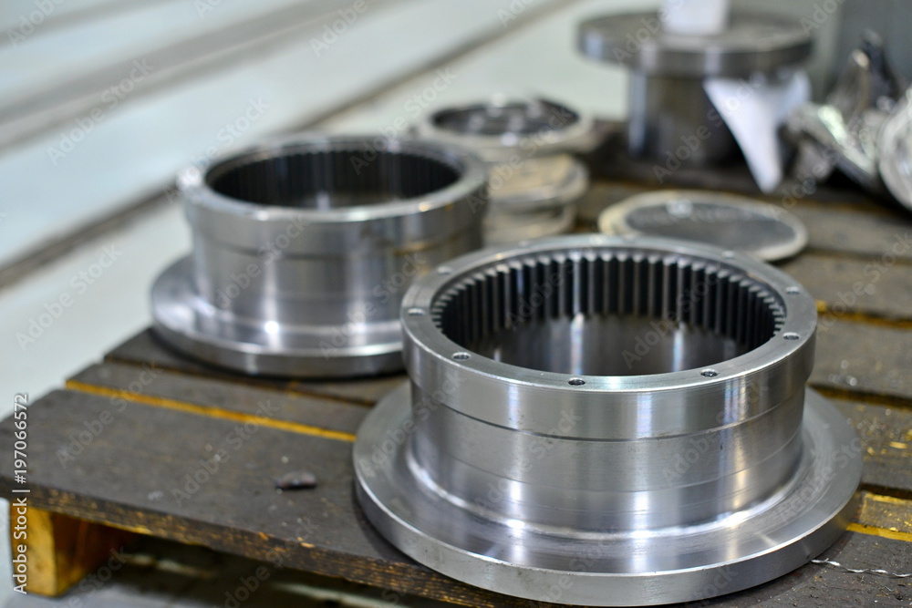 The internal gear after machining on the lathe and CNC milling machine lies on a wooden rack in the shop. The internal gear after machining on the lathe and CNC milling machine lies on a wooden rack in the shop.