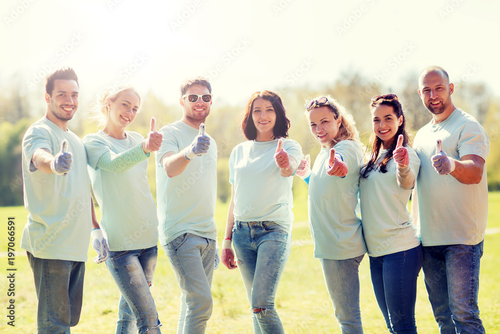 group of volunteers showing thumbs up in park group of volunteers showing thumbs up in park