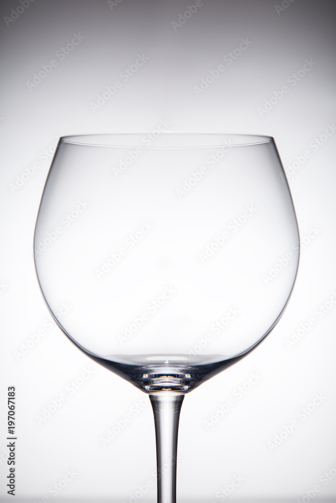 Empty transparent glass for red wine grey gradient background. Empty transparent glass for red wine grey gradient background.