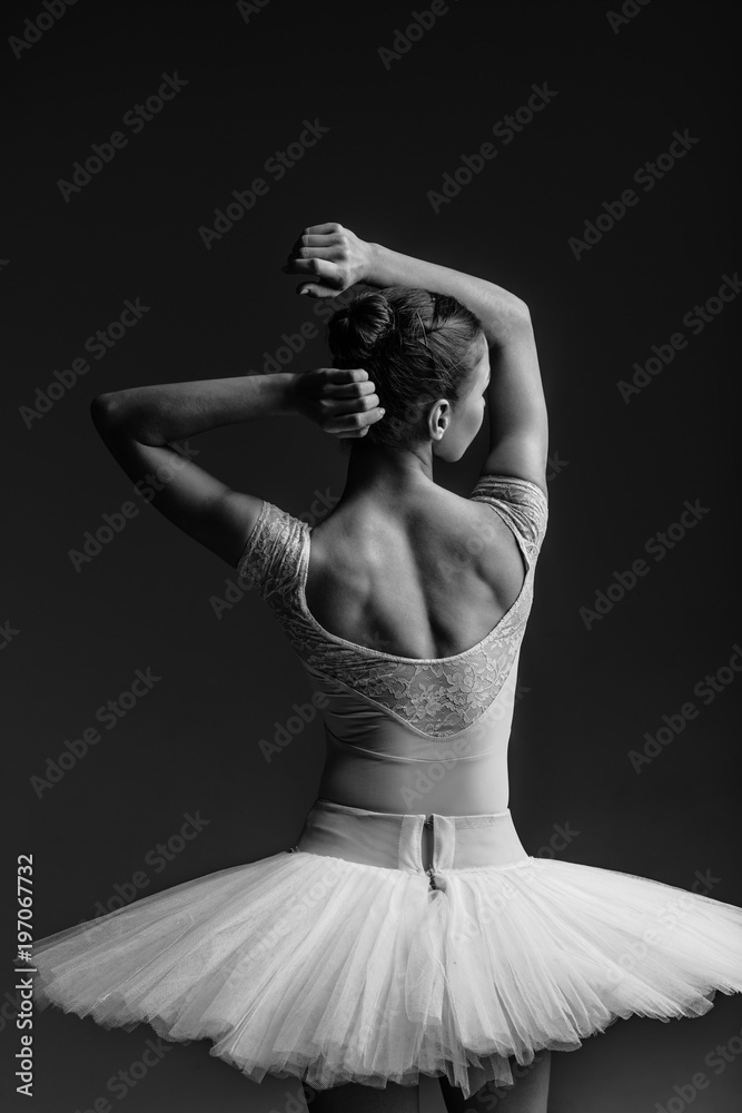 Fototapeta premium Young beautiful ballerina is posing in studio