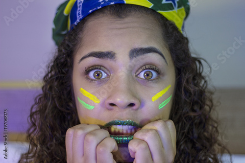 Supporter of Brazil watch on television a tense football game