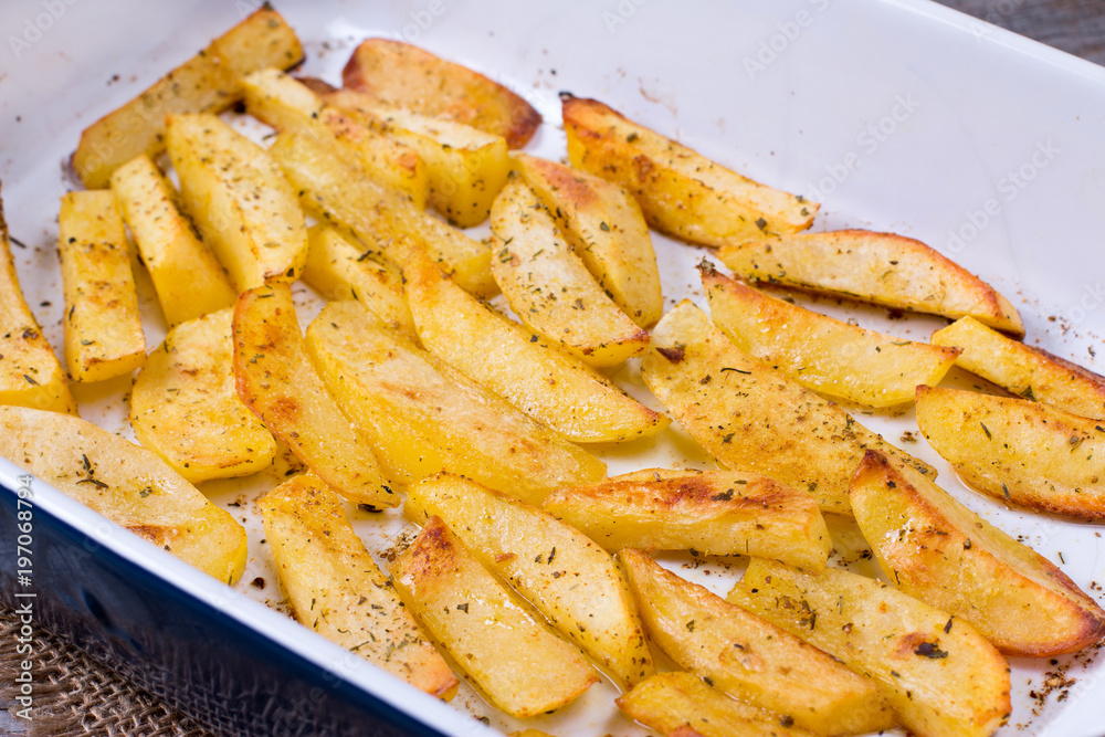 Homemade baked potatoes with spices in a form. Homemade baked potatoes with spices in a form.