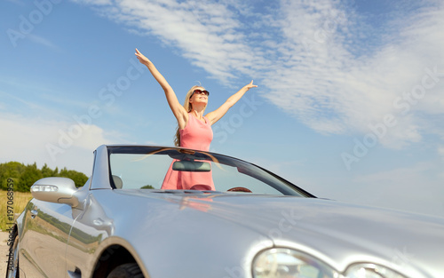 happy young woman in convertible car