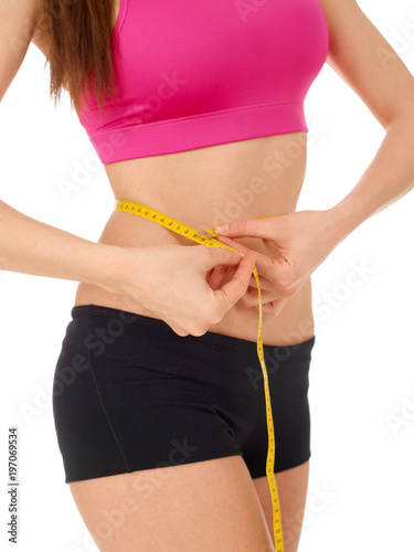 Woman measuring her abdomen