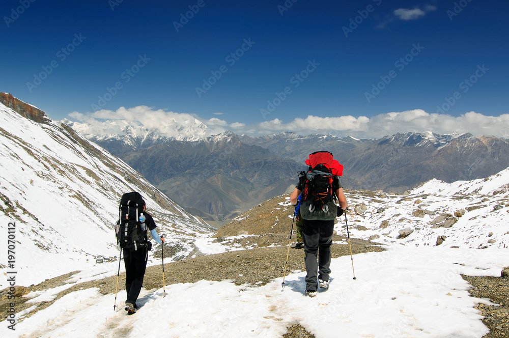 Trek in Nepal. Annapurna cirkut trek. Traveller while climbing to the pass Thorong-la
